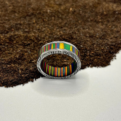 Damascus Steel Ring Lined with Wide Rainbow Wood Sleeve - RustyStudioUSA